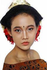 Close up Beautiful Young Woman covering his body with Jarik. a woman using bun with red flowers on hair. Closeup face of young beautiful woman with a healthy clean skin