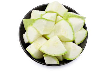 slices of zucchiniin a black plate isolated on white background. Top view