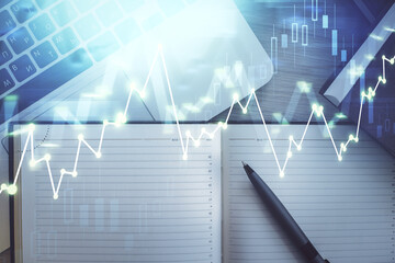 Stock market graph and top view computer on the table background. Multi exposure. Concept of financial education.