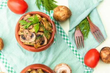 Mushrooms with potatoes and meat cooked in a clay pot in a stone oven.