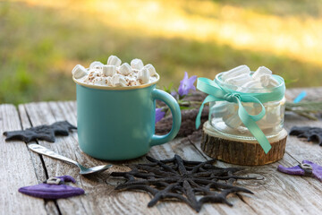 A beautiful coffee drink with small pieces of marshmallow and grated chocolate. On the day of Halloween.