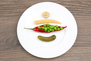 salad of pickled and pickled corn, peas, cucumber and red pepper on a white plate.
