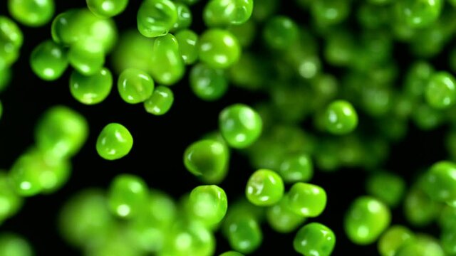 Fresh green peas exploding. Shot with high speed cinematic camera. Super slow Motion.