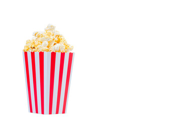 Popcorn in red and white striped cardboard bucket isolated on white background. Movie Popcorn isolated on white with clipping path. Tasty salted popcorn in striped paper cup .