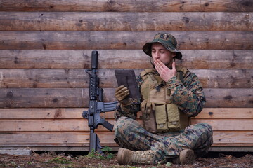 soldier using tablet computer in military camp