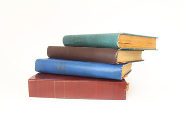 Stack of books in colour covers with white sheets isolated on a white background