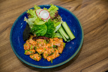 Japanese spicy thai salad sashimi salmon with Premium fresh raw salmon. Asian salad with tofu and fresh vegetables Mixed sliced fish sashimi, thin sliced raw meat salmon , tuna, Sashimi is a Japanese.