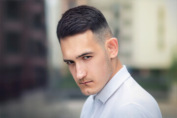 Close up portrait of serious upset handsome man, young sad frustrated offended guy looking at...