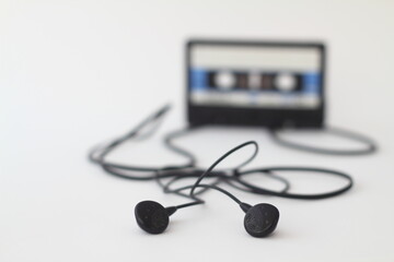 Blue -White audio cassette and cassette pleer with headphones on a white background. Party 90s concept