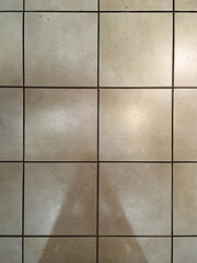 High angle view of the tiled kitchen floor showing light reflections and shadows