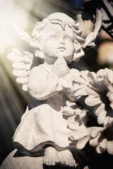 Figure of praying angel. Ancient beautiful statue.