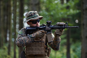 soldier in action aiming  on weapon  laser sight optics