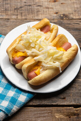 Montreal hot dog with cabbage on wooden background