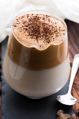 Dalgona coffee in glass cup. Korean trendy drink from instant coffee, milk and brown sugar