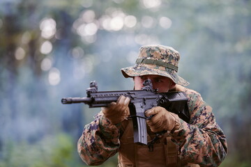 soldier in action aiming  on weapon  laser sight optics