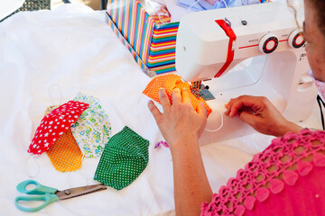Fototapeta premium Woman sewing face masks at her home