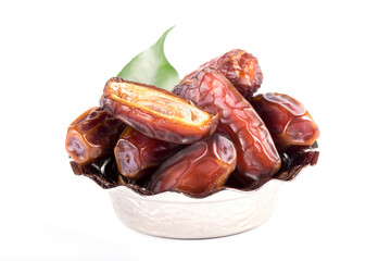 Palm dates on the silver plate, white background.