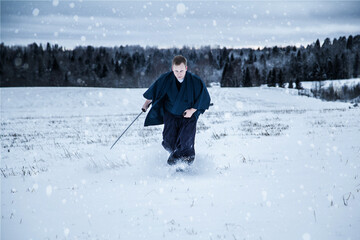 Japanese samurai with sword in a snowy field
