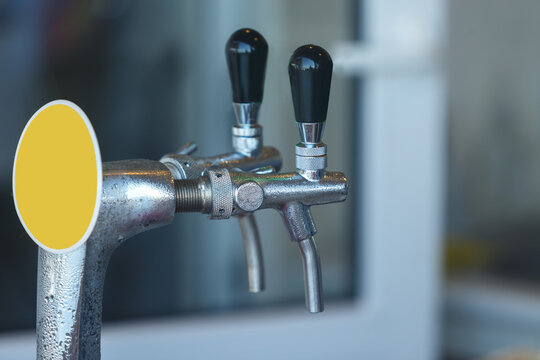Two steaming taps for pouring beer. Close up