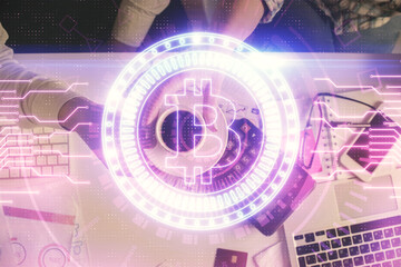 Double exposure of man and woman working together and crypto theme hologram drawing. Computer background. Blockchain concept. Top View.