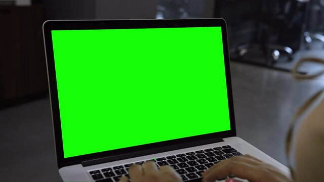 Laptop template with white transparent screen, computer blank display isolated. Metal device. Fingers press keys of the keyboard. Green