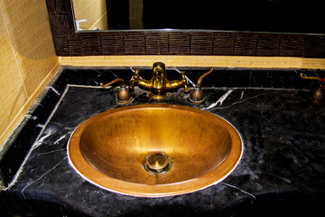 Brass wash basin & water tap in the washroom