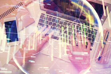 Double exposure of woman hands working on computer and financial theme hologram drawing. Top View. Business concept.