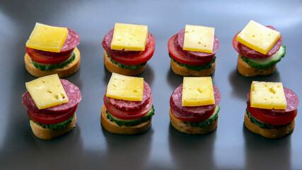 light sandwiches made of vegetables, cheese and sausages. fast food and breakfast