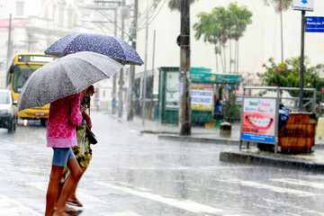 salvador, bahia / brazil - august 26, 2016: People are seen using umbrella during rain in the city...