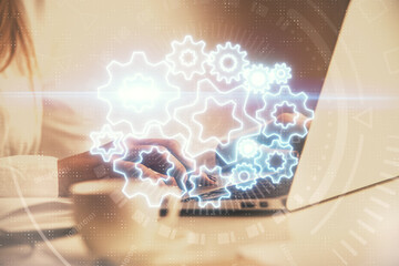 Multi exposure of woman hands typing on computer and business theme hologram drawing. Success concept.