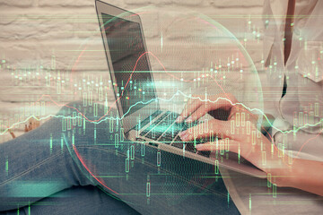 Multi exposure of woman hands typing on computer and forex chart hologram drawing. Stock market analysis concept.