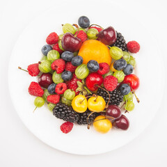 assortment of fresh berries on a white plate. useful vitamin healthy food fruit. healthy vegetable breakfast