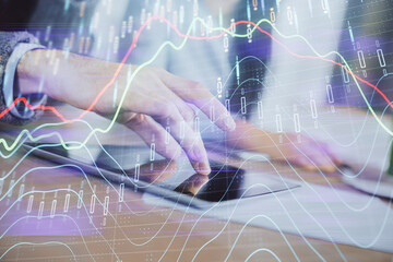 Double exposure of forex graph drawing and man and woman working together holding and using a mobile device. Trade concept.
