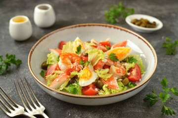Salad with crab meat, shrimp, parmesan, capers, cherry tomatoes and lettuce. Healthly food. © chudo2307