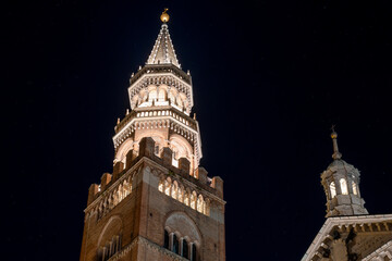Fototapeta na wymiar Torrazzo of Cremona. Located next to Cremona Cathedral, it is the symbol of the city. It is the tallest masonry bell tower in Europe, 112 meters.