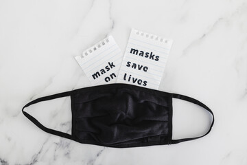 protection against the covid-19 virus outbreak, reusable fabric face mask with text Masks save lives