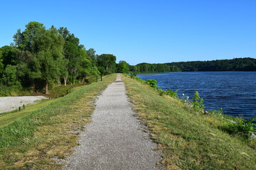 Fototapeta na wymiar Barton dam, Ann Arbor. Summer landscape with a long riverside walkway beside Huron river