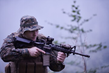 soldier in action aiming  on weapon  laser sight optics