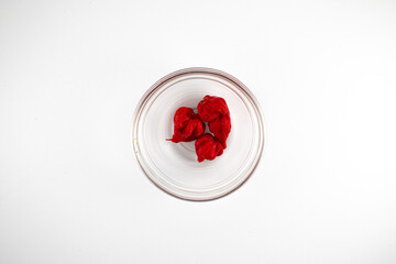 Top down photo of three ghost peppers in a glass bowl