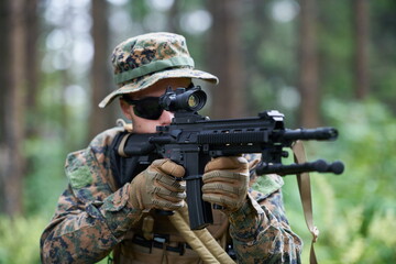 soldier in action aiming  on weapon  laser sight optics