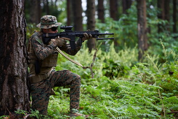soldier in action aiming  on weapon  laser sight optics