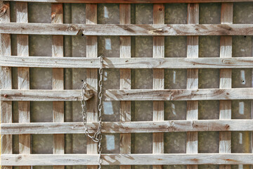 old wooden fence with old chain hanging