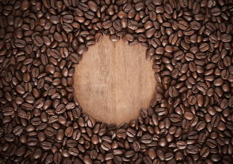 Roasted coffee bean background with a spherical space in the middle.