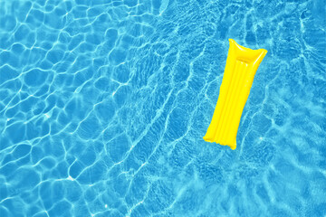 Swimming pool with inflatable mattress, top view. Space for text