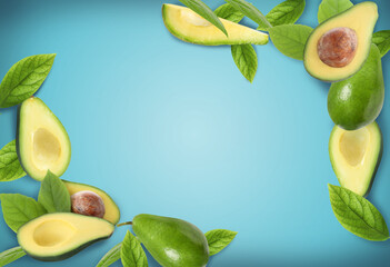 Composition with ripe avocados on blue background. Space for text