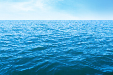 Fototapeta premium Beautiful ripply sea under blue sky with clouds