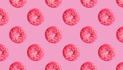 Creative pattern design of glazed donuts on pink background, banner