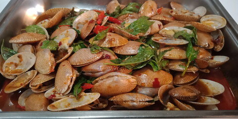 Stir-Fried Clams with Green Basil Vegetables are herbs, spicy Thai food, delicious and useful appetizer.