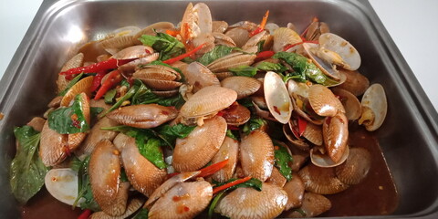 Stir-Fried Clams with Green Basil Vegetables are herbs, spicy Thai food, delicious and useful appetizer.
