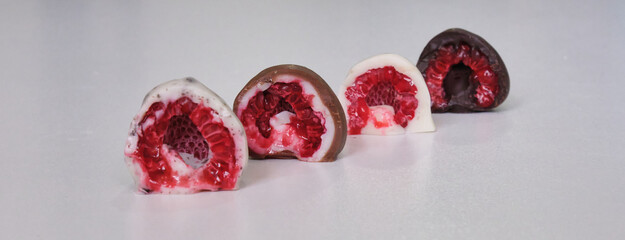 raspberries dipped or covered in mold chocolate . white chocolate, milk chocolate, dark chocolate...